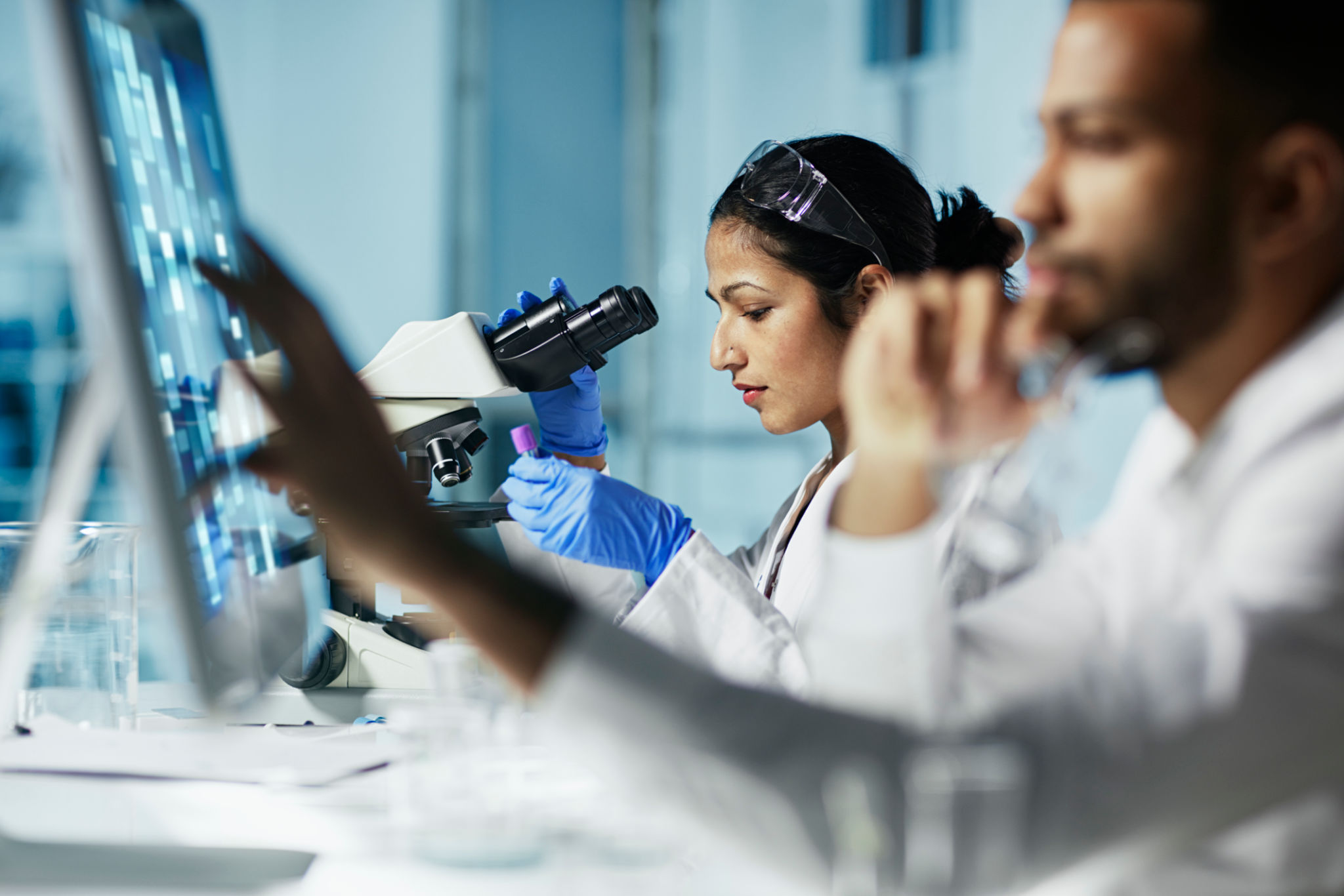 Scientist Working on Computer In Modern Laboratory NOTE TO INSPECTOR: all graps, dna models, charts are made by me